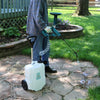 person spraying paving stones with battery powered sprayer