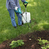 Person spraying garden bed with battery powered sprayer